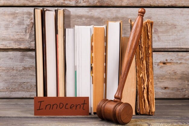 A gavel resting on a stack of legal documents with the words 
