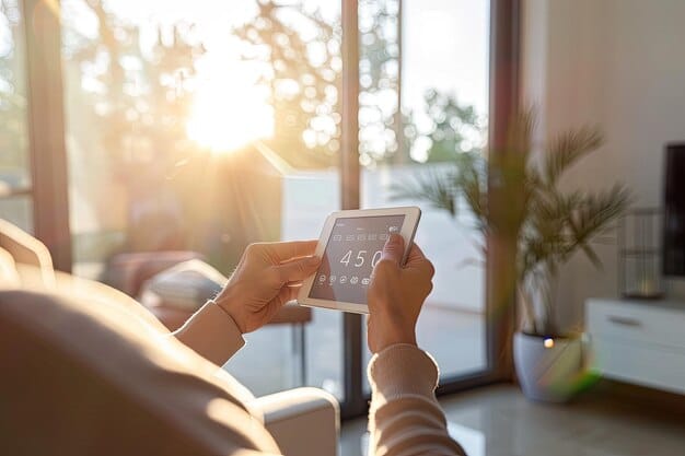 A person holding a tablet displaying a list of app permissions. They are carefully reviewing each permission before granting access. The background is a blurred view of a living room.