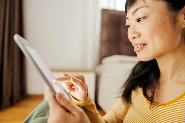 A close-up shot of a person using a tablet or phone to watch a Korean drama, with headphones on. The screen displays a scene from the K-drama, focusing on the emotional expressions of the actors, and the shot is taken in a dimly lit environment, suggesting the viewer is enjoying the show in the evening or at night.