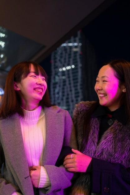 A picture taken during a K-Drama fan meeting in a US venue. Prominently feature the actors or actresses on stage, interacting with the audience. Capture the energy and excitement of the event, with fans cheering, holding banners, or participating in on-stage games.